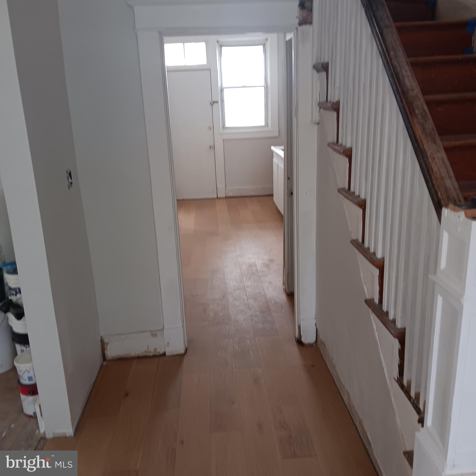 2419 Mosher Street Baltimore, MD 21216 - Photo 3 of 19 a view of a hallway with wooden floor and staircase