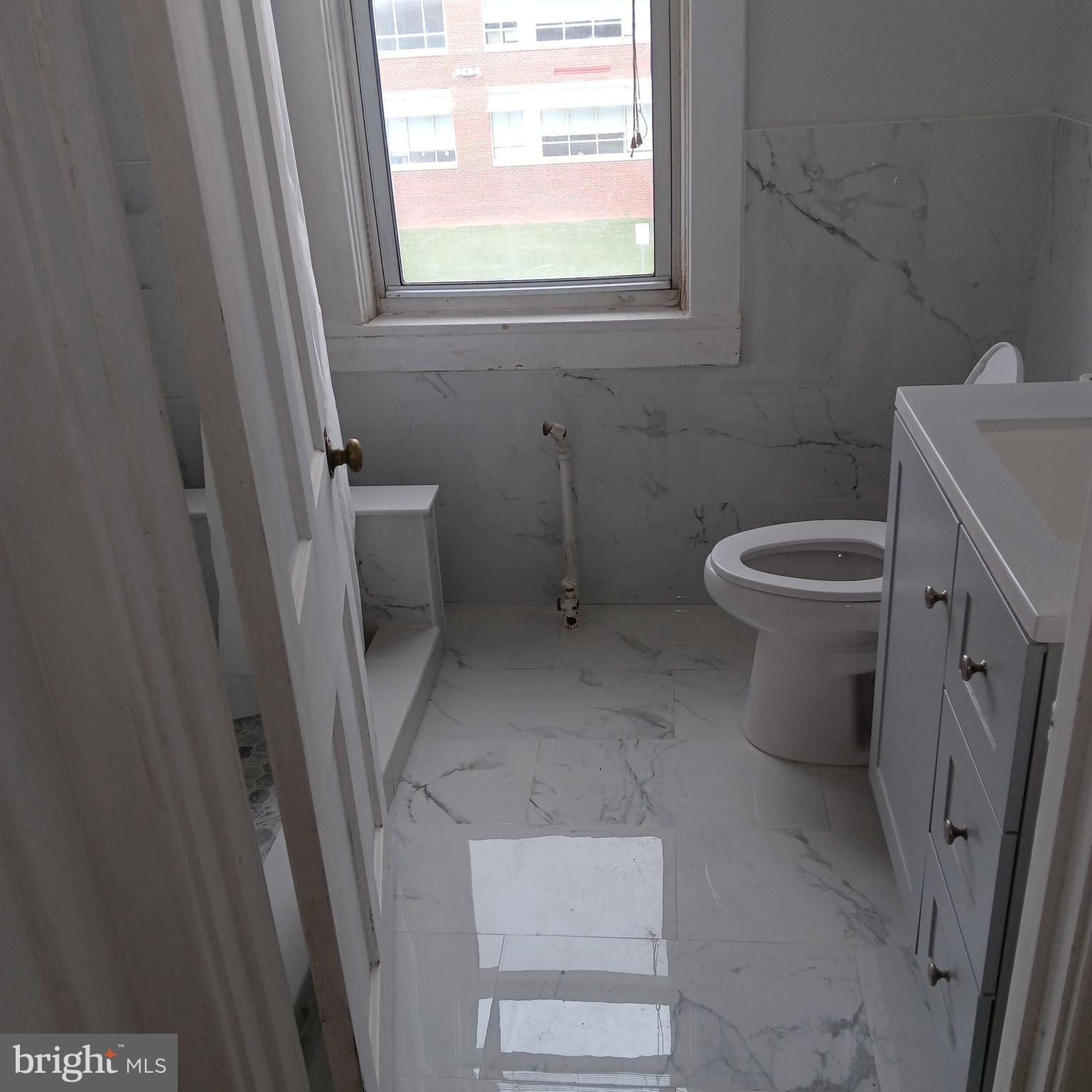 2419 Mosher Street Baltimore, MD 21216 - Photo 5 of 19 a bathroom with a toilet and a sink