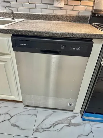 a stove top oven sitting inside of a kitchen