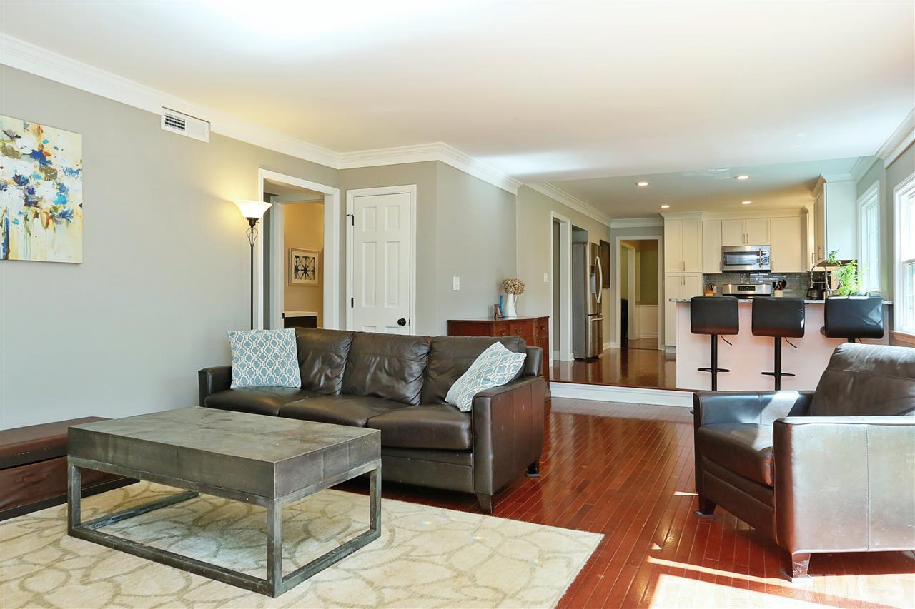 7101 Tanbark Way Raleigh, NC 27615 - Photo 11 of 25 a living room with furniture and a view of kitchen