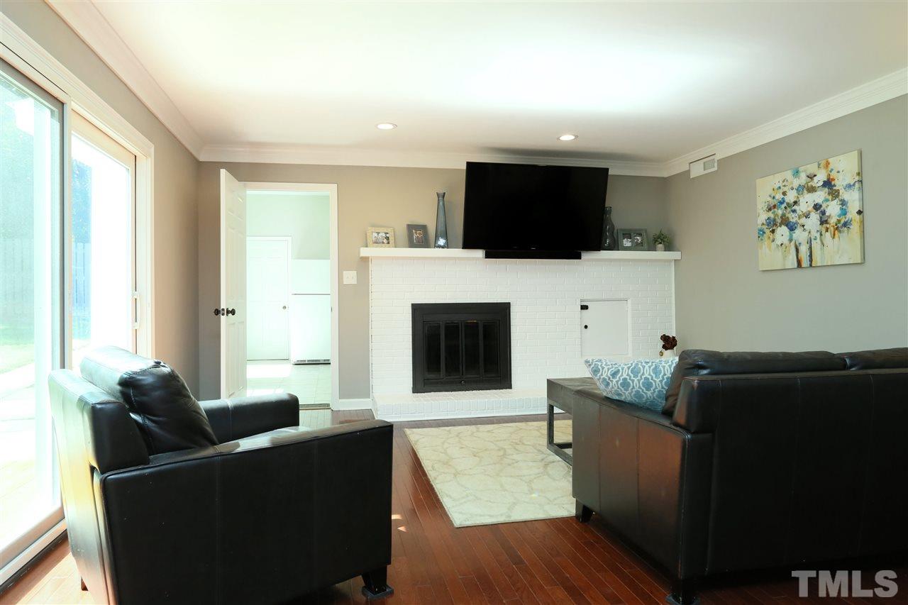 7101 Tanbark Way Raleigh, NC 27615 - Photo 12 of 25 a living room with furniture and a flat screen tv