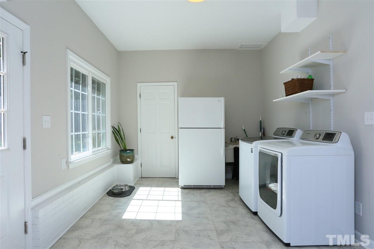 7101 Tanbark Way Raleigh, NC 27615 - Photo 13 of 25 a utility room with dryer and washer