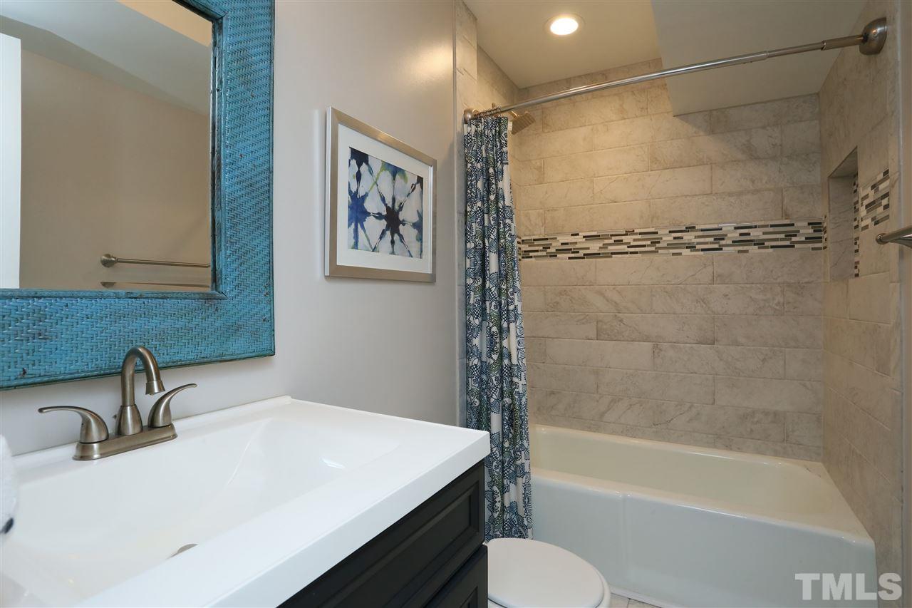 7101 Tanbark Way Raleigh, NC 27615 - Photo 14 of 25 a bathroom with a sink a toilet and shower