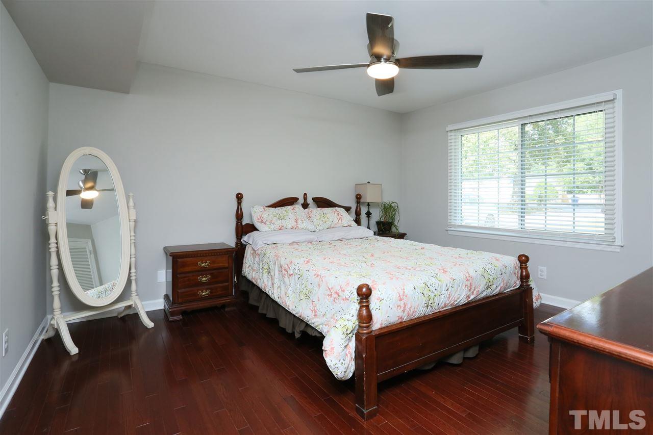 7101 Tanbark Way Raleigh, NC 27615 - Photo 16 of 25 a bed sitting in a bedroom next to a window