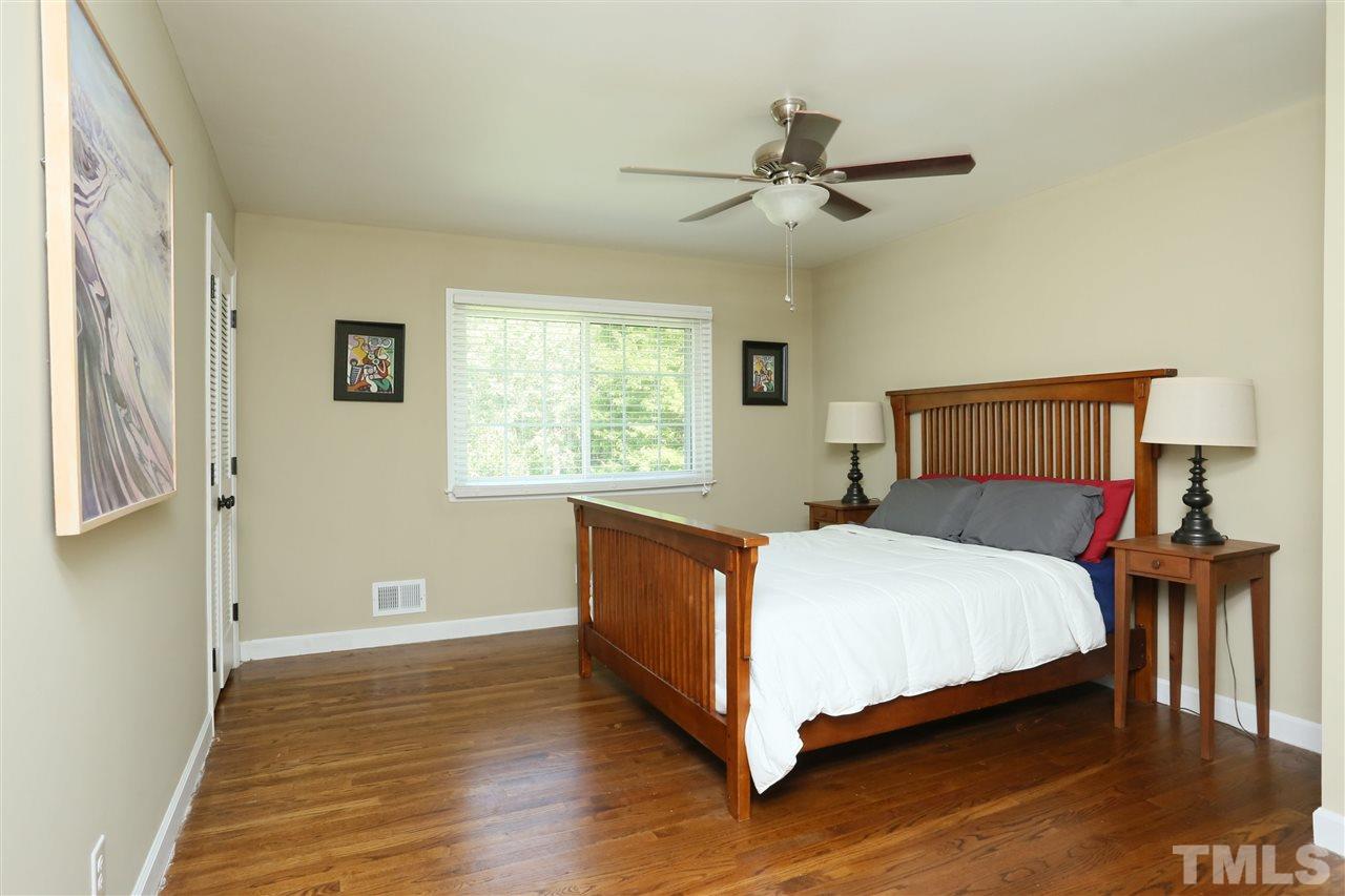 7101 Tanbark Way Raleigh, NC 27615 - Photo 19 of 25 a bedroom with a bed and window