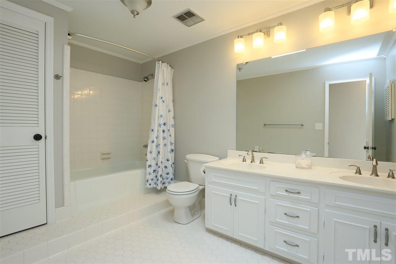 7101 Tanbark Way Raleigh, NC 27615 - Photo 20 of 25 a spacious bathroom with a double vanity sink mirror and toilet