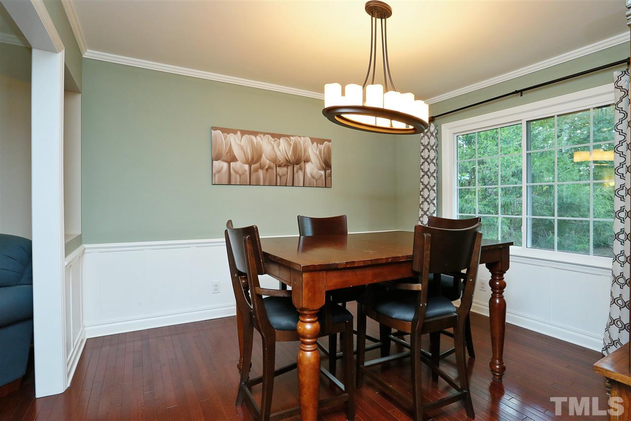 7101 Tanbark Way Raleigh, NC 27615 - Photo 3 of 25 a view of a dining room with furniture window and wooden floor