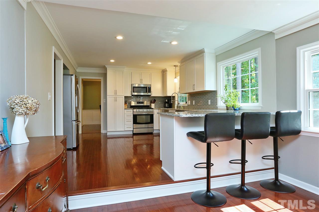 7101 Tanbark Way Raleigh, NC 27615 - Photo 8 of 25 a kitchen with kitchen island a counter top space appliances and a window