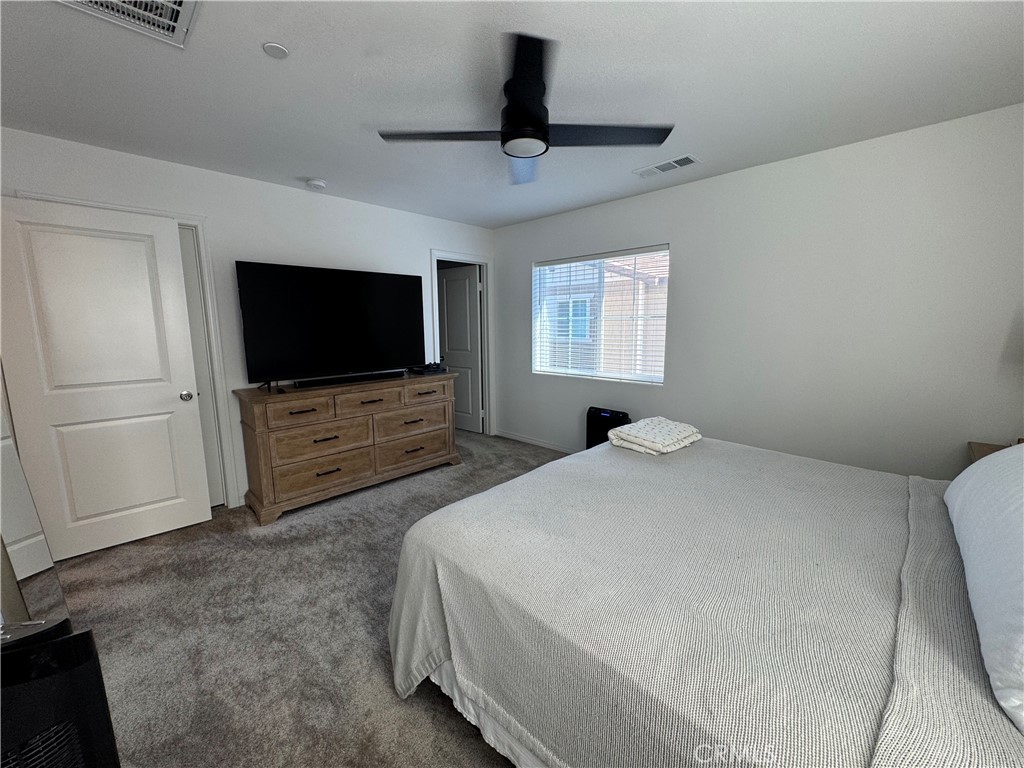 19167 Sequoia Grv Street Riverside, CA 92507 - Photo 19 of 30 a bedroom with a bed and a flat screen tv