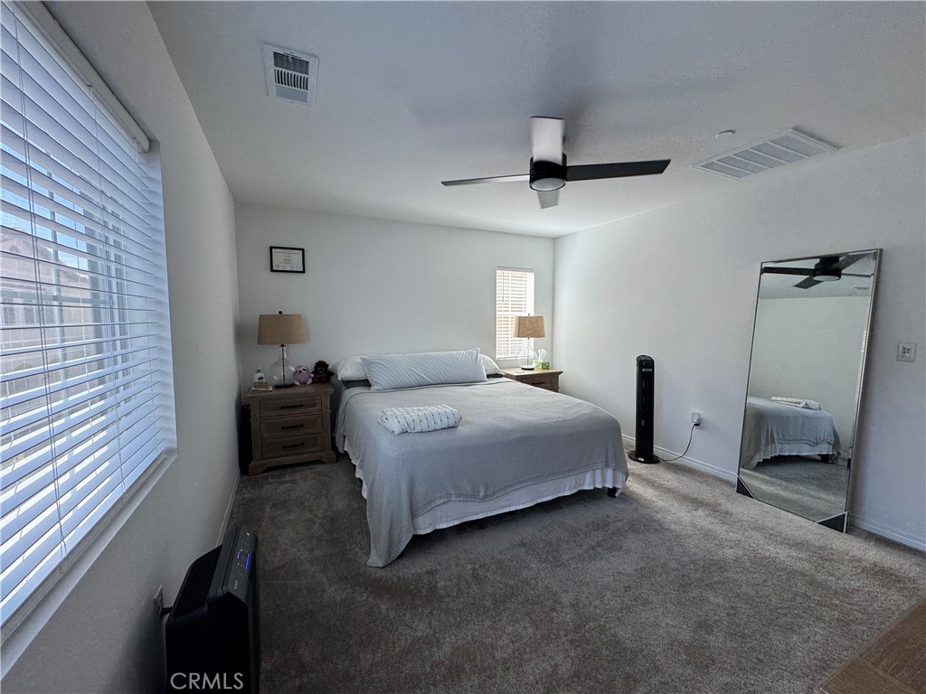 19167 Sequoia Grv Street Riverside, CA 92507 - Photo 20 of 30 a bedroom with a bed and a chandelier