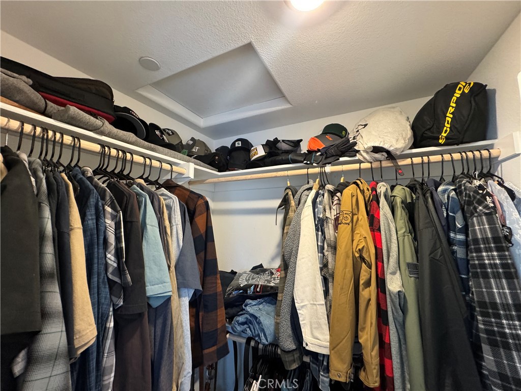 19167 Sequoia Grv Street Riverside, CA 92507 - Photo 28 of 30 a view of walk in closet with clothes and shoes