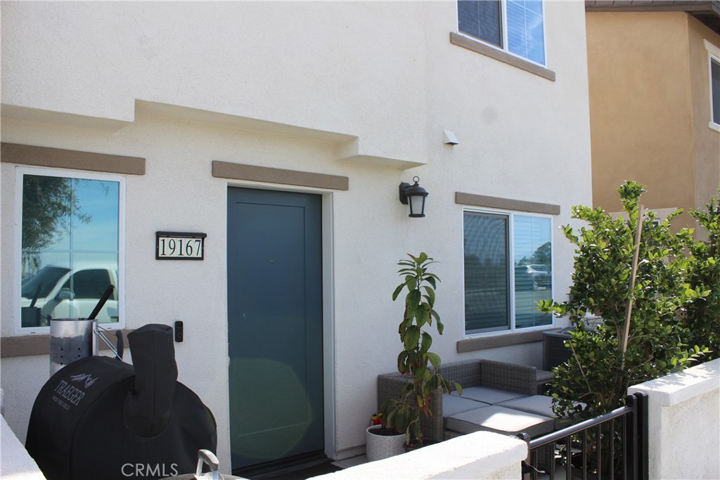 19167 Sequoia Grv Street Riverside, CA 92507 - Photo 5 of 30 a front view of a house with yard