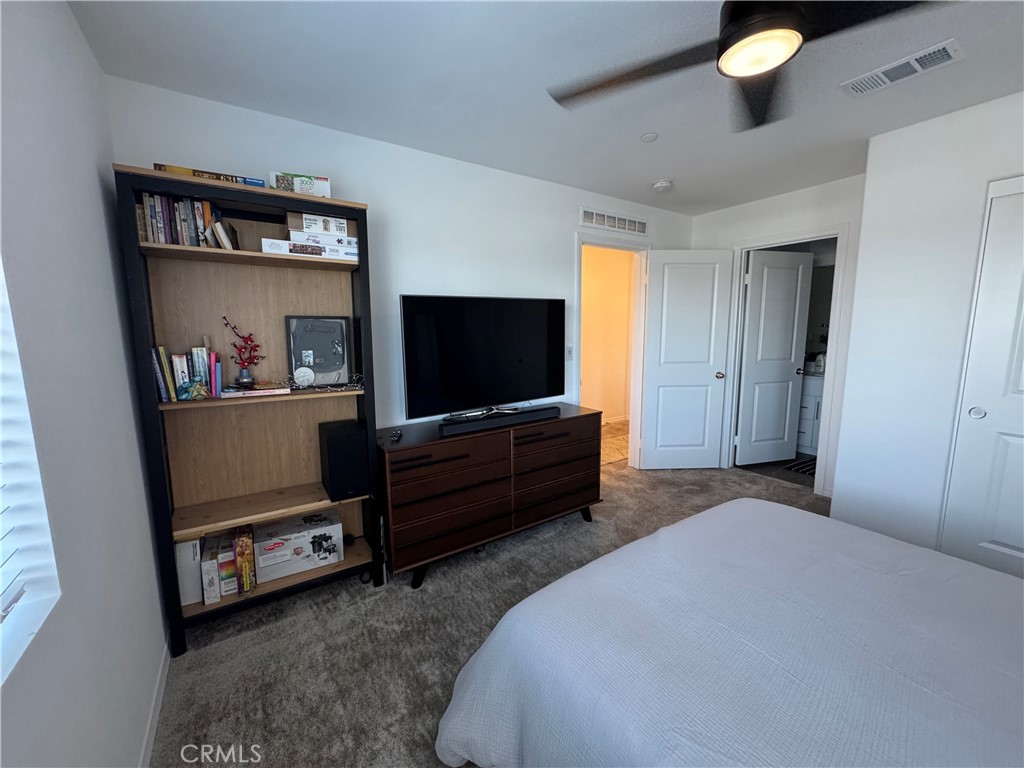 19167 Sequoia Grv Street Riverside, CA 92507 - Photo 8 of 30 a bedroom with furniture and a flat screen tv