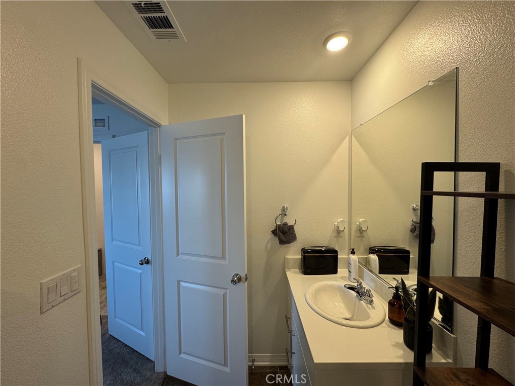 19167 Sequoia Grv Street Riverside, CA 92507 - Photo 9 of 30 a bathroom with a sink toilet and tub