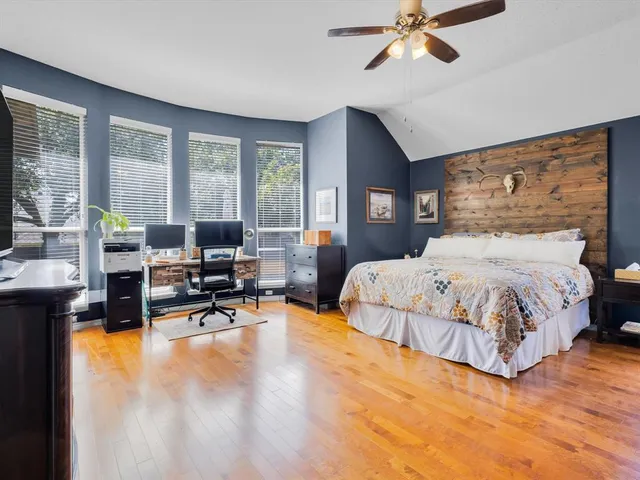 a bedroom with a large bed and a chandelier