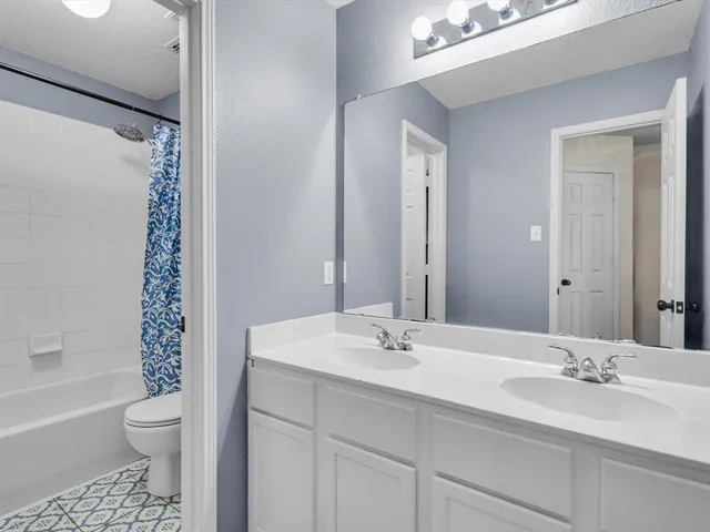 a bedroom with furniture and a flat screen tv