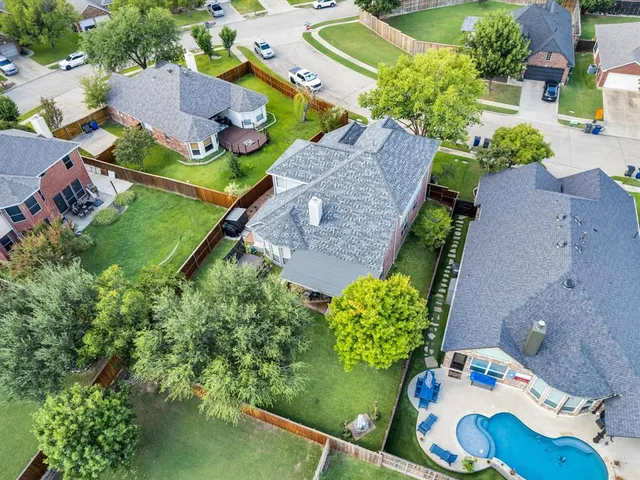 an aerial view of residential houses with outdoor space