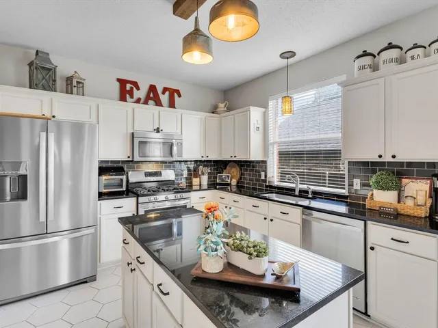 a bathroom with a granite countertop sink