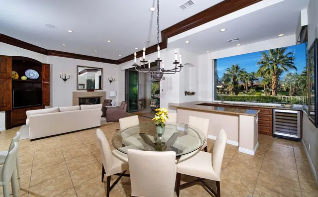 a living room with stainless steel appliances kitchen island granite countertop furniture and a view of kitchen