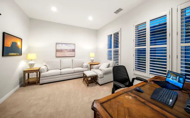 a swimming pool with outdoor seating and yard