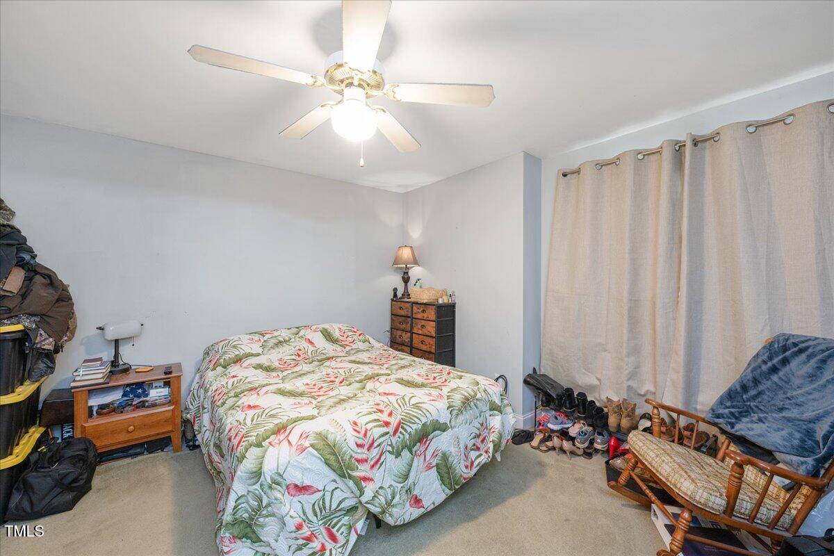 604 Sinewell Drive Wake Forest, NC 27587 - Photo 14 of 25 a bedroom with bed and a chandelier