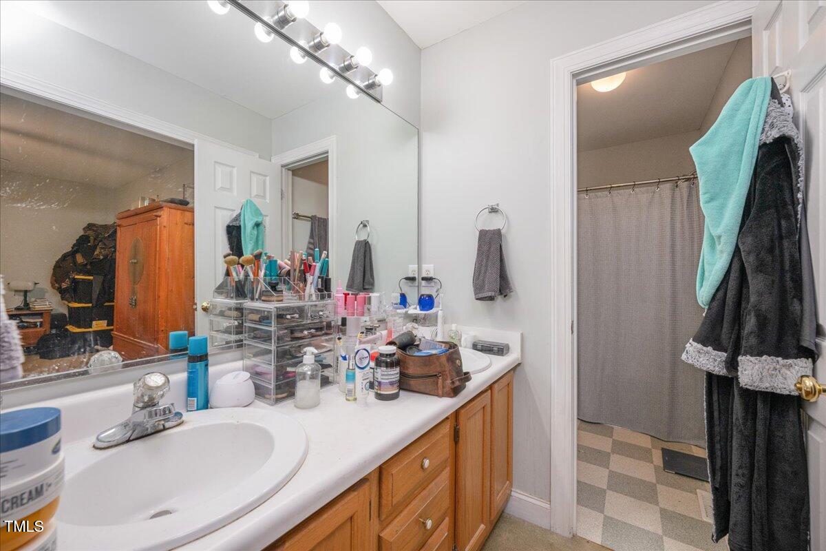 604 Sinewell Drive Wake Forest, NC 27587 - Photo 15 of 25 a bathroom with a double vanity sink and a mirror