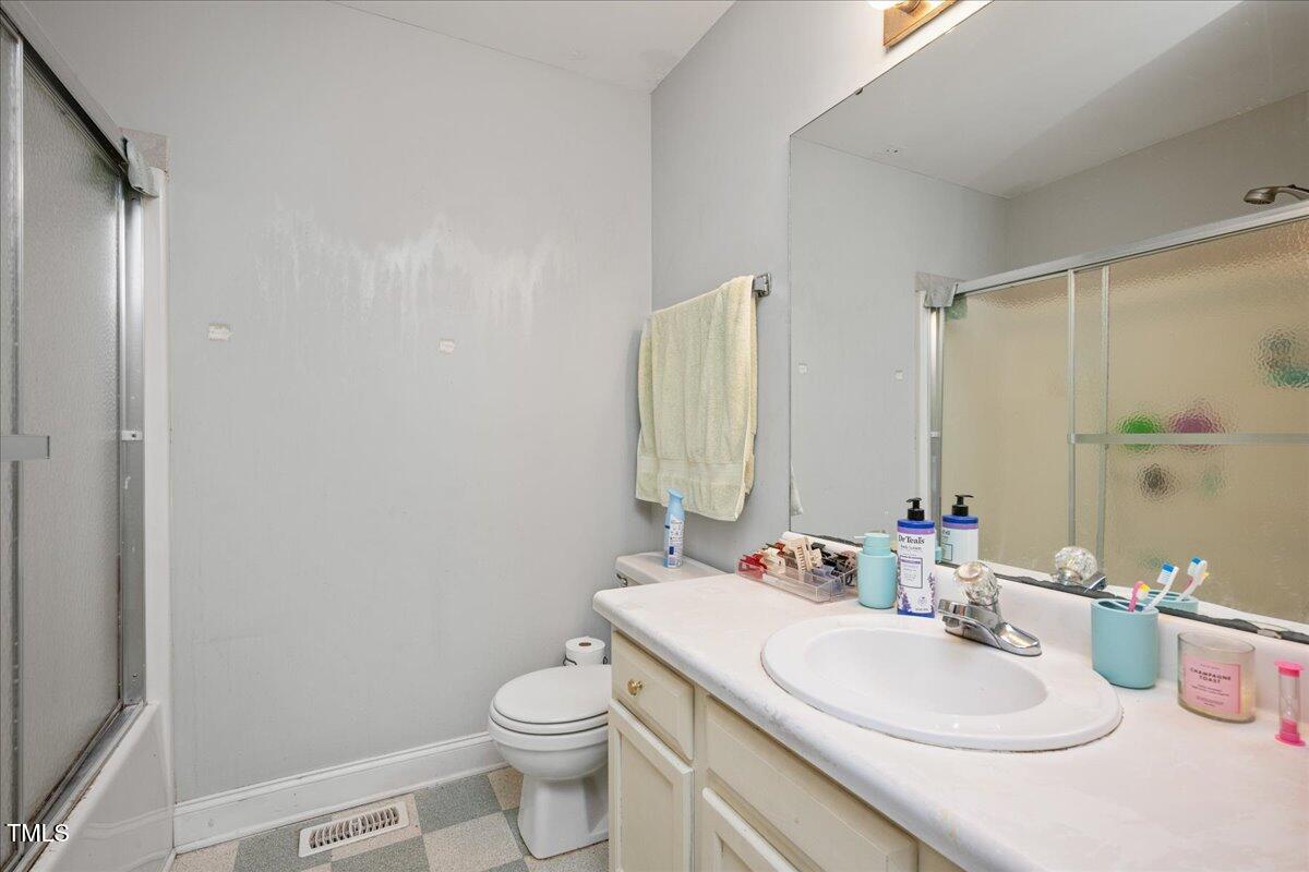 604 Sinewell Drive Wake Forest, NC 27587 - Photo 18 of 25 a bathroom with a sink toilet and a mirror