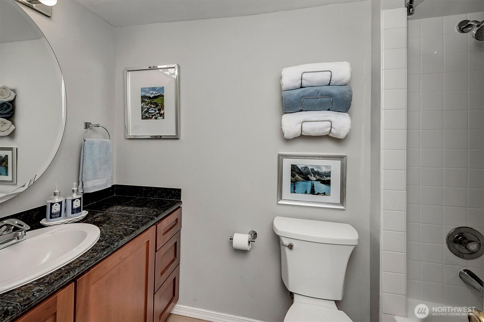 300 10th Avenue, Unit B205 Seattle, WA 98122 - Photo 11 of 27 a bathroom with a granite countertop toilet sink and mirror