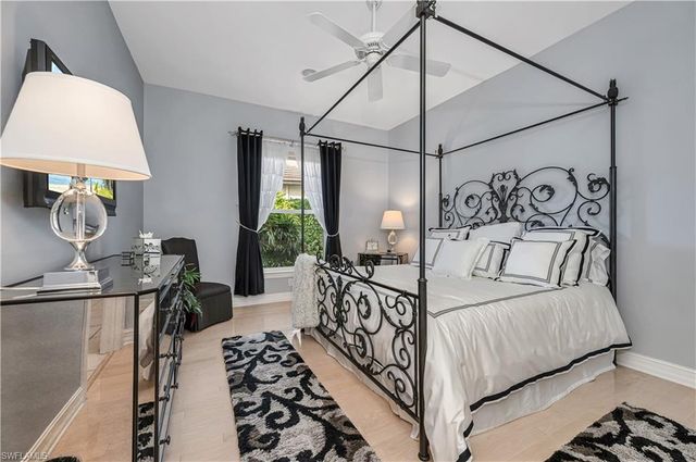 a bedroom with a bed and a chandelier