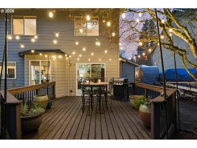 a view of a patio with table and chairs with wooden floor