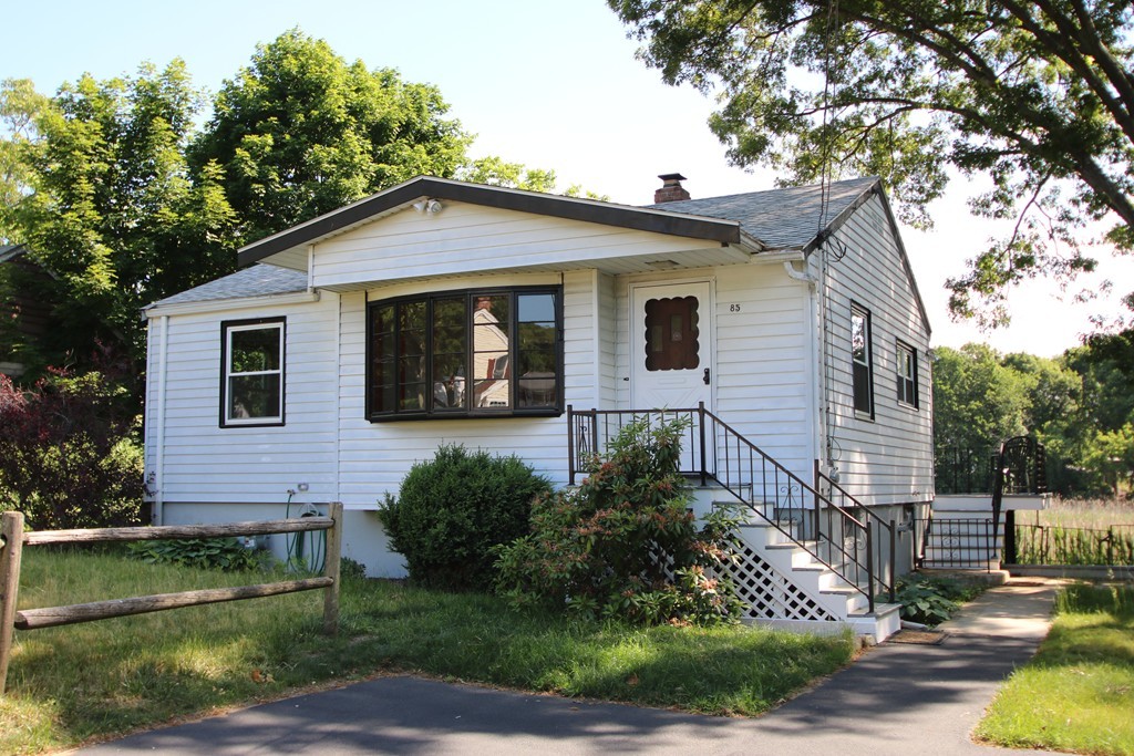 85 Riverbank Road Saugus, MA 01906 - Photo 1 of 20 a front view of a house with garden