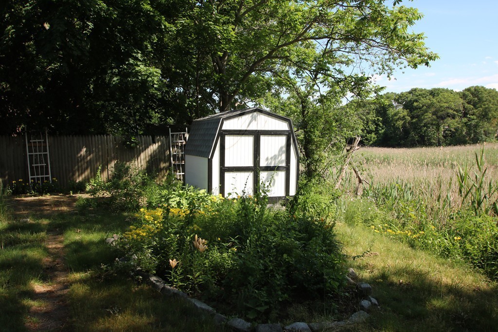 85 Riverbank Road Saugus, MA 01906 - Photo 16 of 20 a view of a garden with plants and large trees