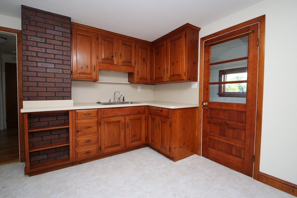 85 Riverbank Road Saugus, MA 01906 - Photo 2 of 20 a kitchen with granite countertop cabinets and window