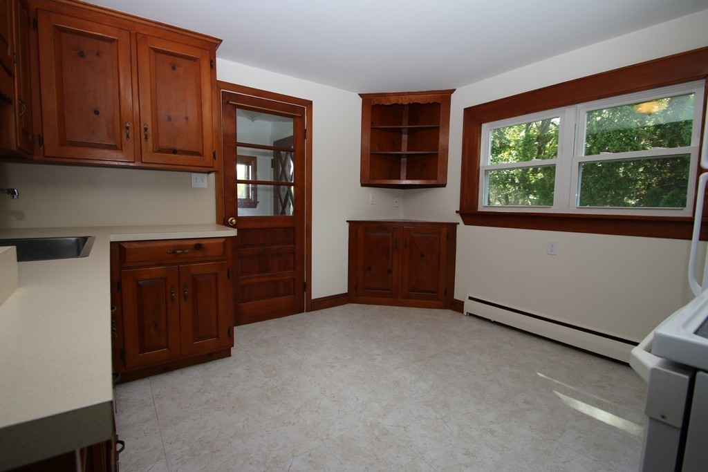 85 Riverbank Road Saugus, MA 01906 - Photo 3 of 20 a view of an empty room with a cabinet and a window