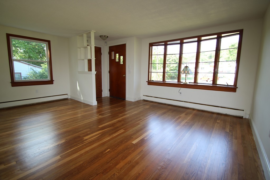 85 Riverbank Road Saugus, MA 01906 - Photo 6 of 20 a view of an empty room with wooden floor and a window