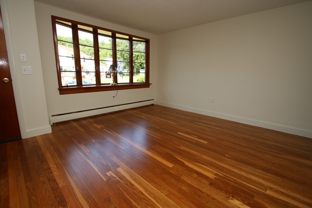 85 Riverbank Road Saugus, MA 01906 - Photo 7 of 20 a view of an empty room with wooden floor and a window
