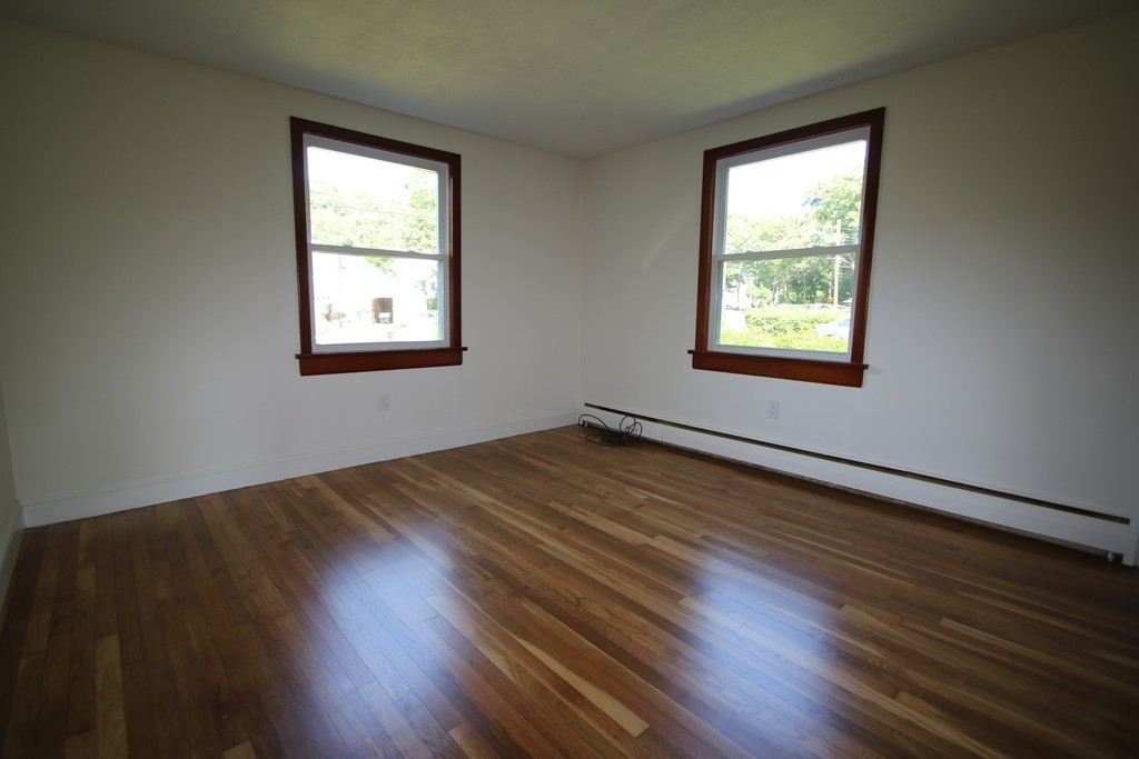 85 Riverbank Road Saugus, MA 01906 - Photo 9 of 20 an empty room with wooden floor and windows