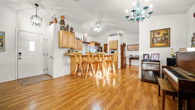 a view of a living room and kitchen with wooden floor