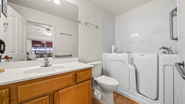 a bathroom with a sink a toilet and a mirror