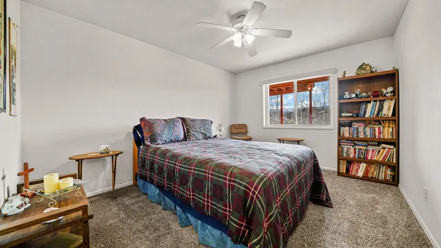 a bedroom with a bed a dresser and a book shelf