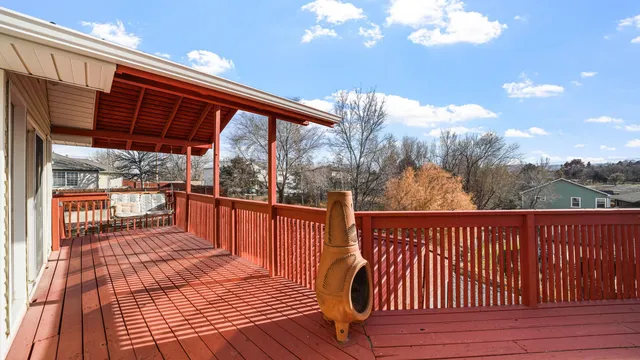a view of a roof deck with couches and wooden floor