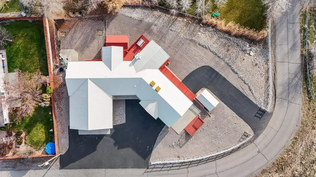 an aerial view of a house with a yard and potted plants
