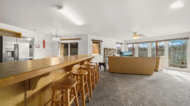 a living room with furniture a flat screen tv and a large window