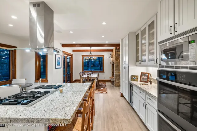 a kitchen with stainless steel appliances granite countertop a stove and a sink