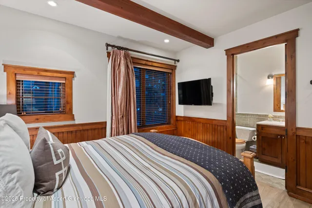 a bedroom with a bed and a fireplace