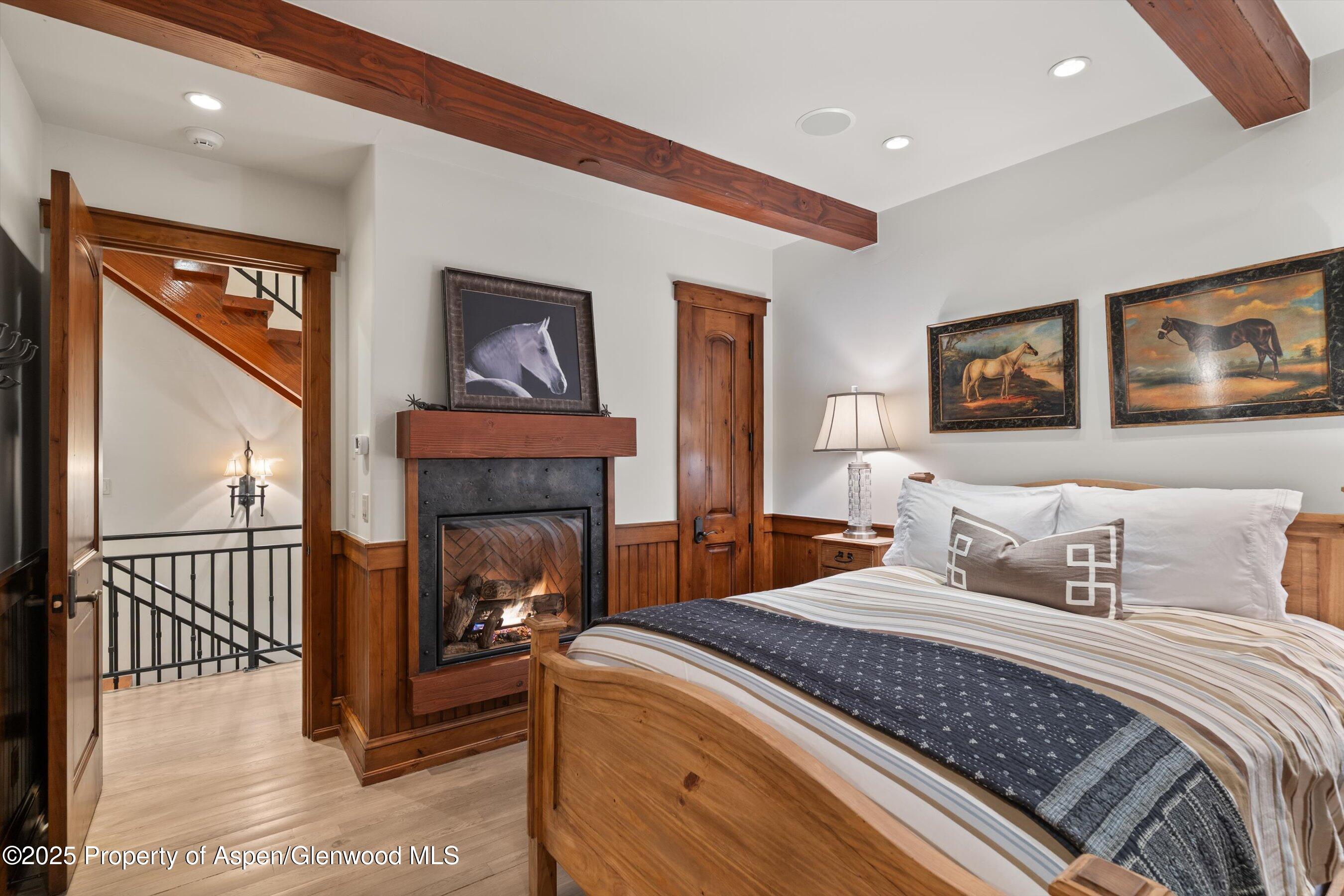 1430 Sierra Vista Drive Aspen, CO 81611 - Photo 16 of 57 a bedroom with a bed and a fireplace