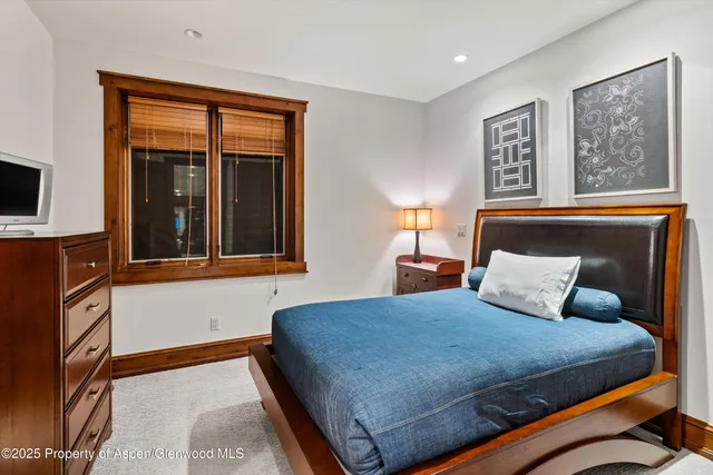 a bedroom with a large bed and a large window