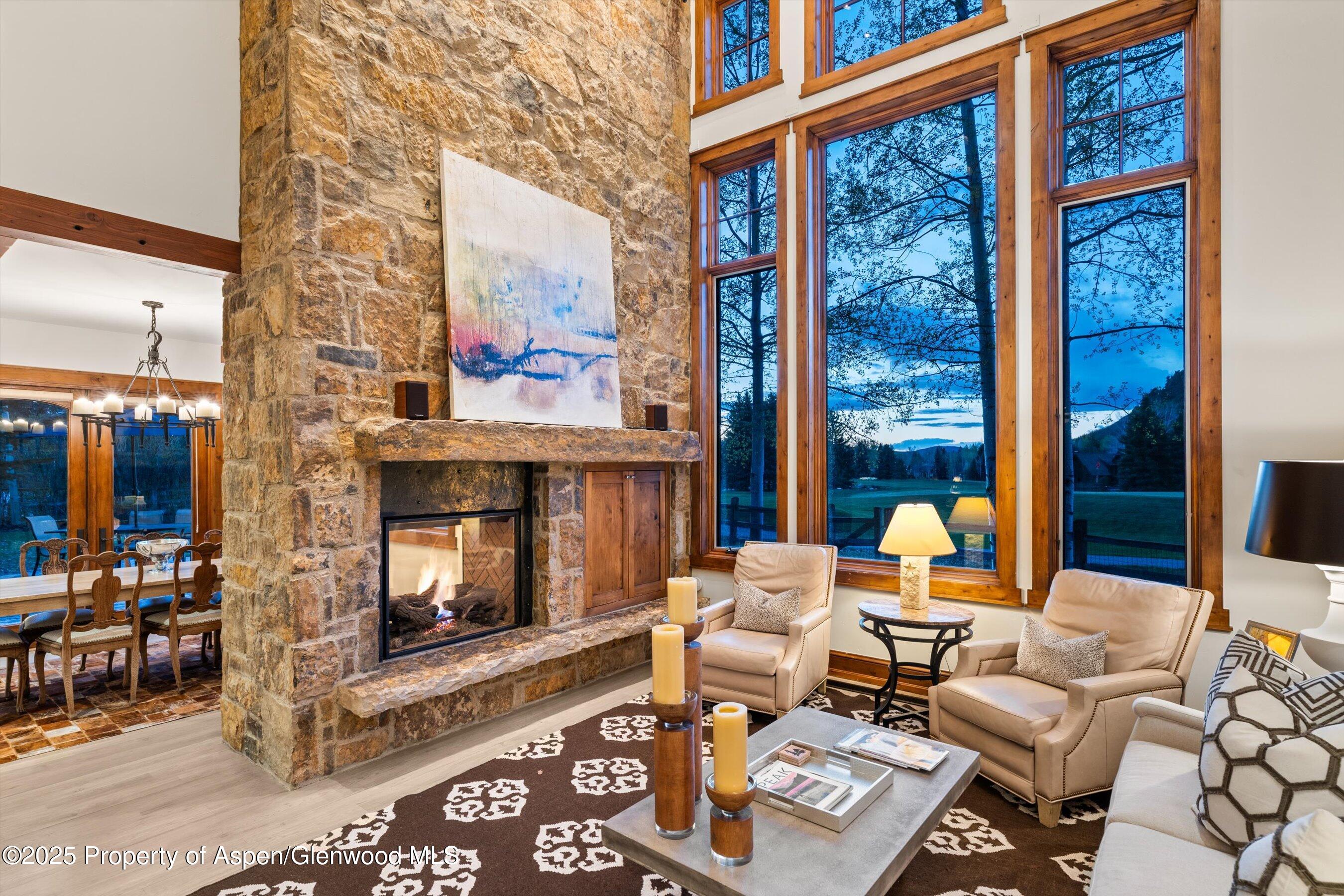 1430 Sierra Vista Drive Aspen, CO 81611 - Photo 2 of 57 a living room with furniture a fireplace and a floor to ceiling window