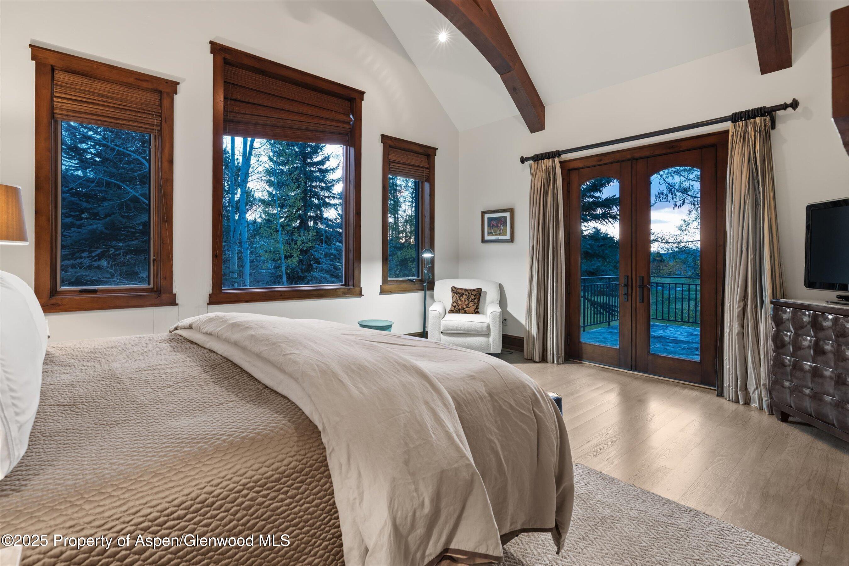 1430 Sierra Vista Drive Aspen, CO 81611 - Photo 21 of 57 a bedroom with a large bed and a large window