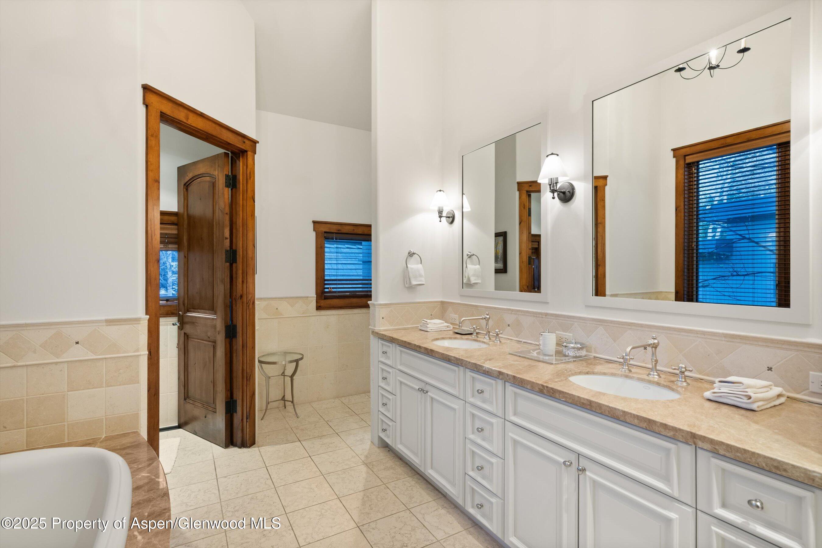 1430 Sierra Vista Drive Aspen, CO 81611 - Photo 22 of 57 a bathroom with a granite countertop sink and a mirror
